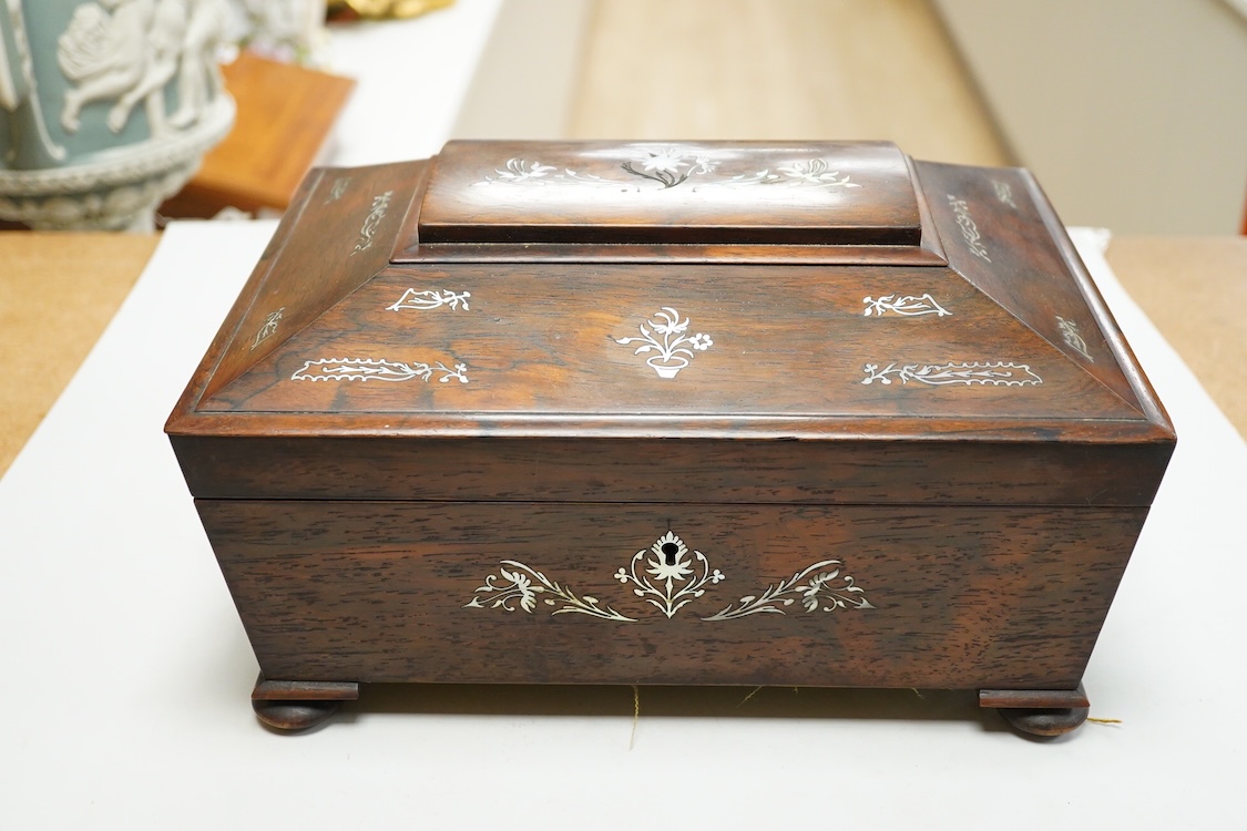 A Victorian mother of pearl inlaid rosewood sewing box and contents including a silver thimble and carved bone thread reels, 33cm wide